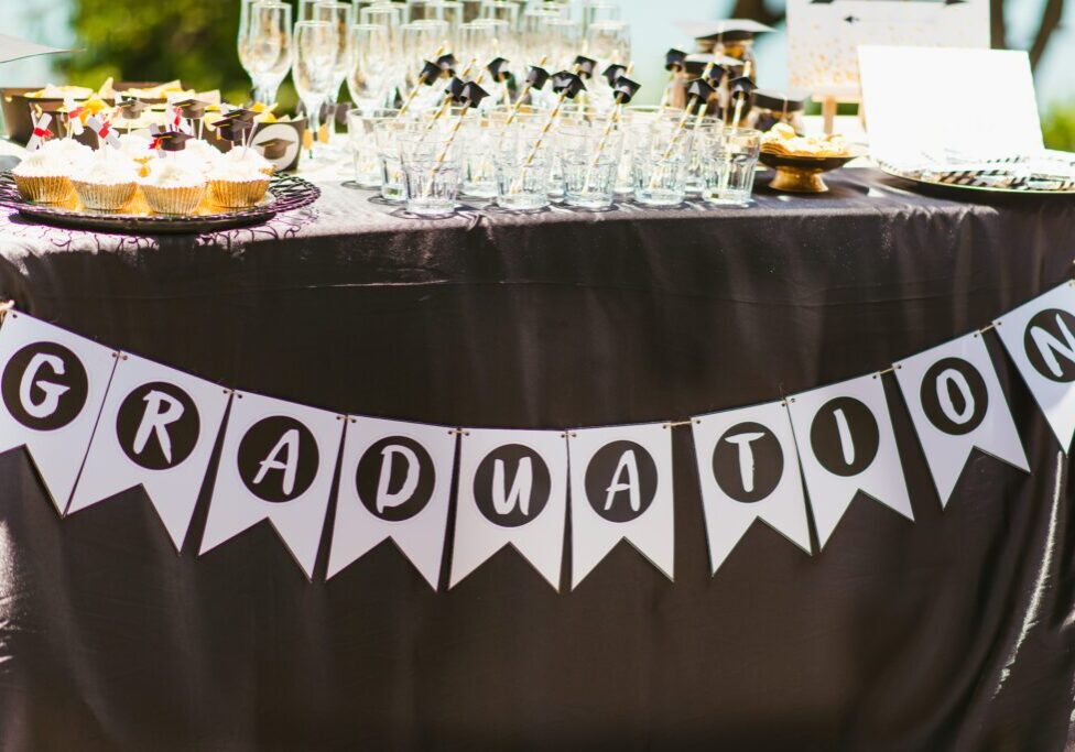 Table of Party Favors with a Banner that Says "Graduation"